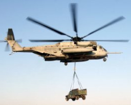 A helicopter holding a truck